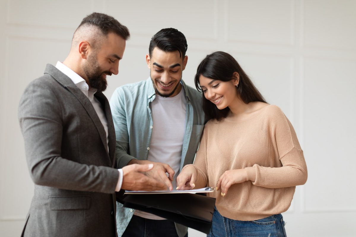 couple-buying-new-apartment-house-agent-showing-documents-blueprints.jpg